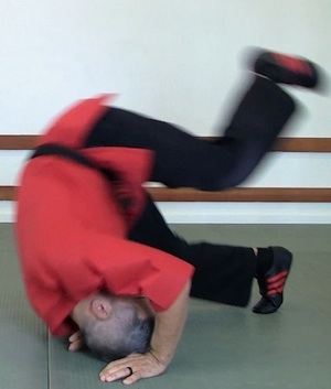 Forward rolls with hands by head.